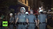 Police batter anti-Olympic protesters with batons in Sao Paulo.