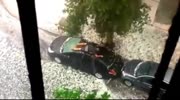 Man Desperately Tries to Protect Car From Hail