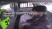 suspect being ejected from police cruiser.