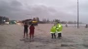 car jumping out of sea foam in Queensland Australia cyclone floods.
