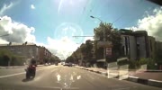 Biker loses control and slides under the bus