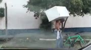 Guy carrying fridge on his back