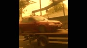 Car drives off tow truck