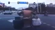 Scooter explodes into flames at traffic light.