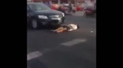 Woman pretends to get hit by car