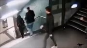 Migrants kick woman down stairs
