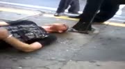 Agressive man attacks a cop and gets nearly choked by a guy from a crowd