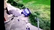 Driver dives from dump truck milliseconds before it falls over a cliff.