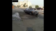 Two Punks wreck a car outside a Mechanics shop