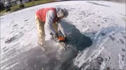 Cutting Out a Pike Eating a Bass Frozen in Ice