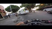 Speeding biker slides under the bus