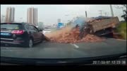 Car And Its Occupants Buried By Truckload Of Bricks.