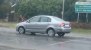 Naked man rides car