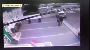 Two men shoot each other laying on the road