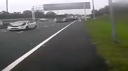 ACCELERATES THE CAR BEFORE CHUCKING AGAINST A CAR FROM THE CAMERA