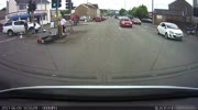 man on motorcycle crashes traffic light