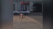 Naked man shits in the middle of a busy road