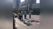 Rider falls under a turning bus