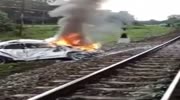 Car is on fire after being hit by rail