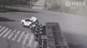 Truck overturns crushing two cars
