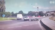 Motorcyclist falls head first under the car