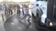 Cops break protesters neck with water cannon