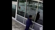 MAN TRYING TO SMASH WINDOW OF POLICE STATION