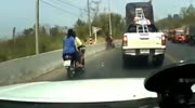 Drivers arguing on a roadside are interrupted by a truck