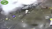 Car at a gas station explodes.