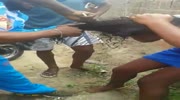 Three girls get their hair violently cut and beaten after they were caught stealing in slums