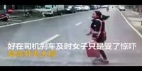 Woman falls and lands under a box truck, inches from her head being ran over