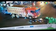 Female scooter passenger falls under the truck and gets crushed