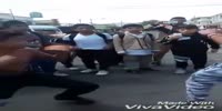 Fighting guy falls under the car and gets his leg run over