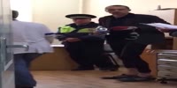 Drugged man dances in a police station