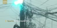 Man gets stuck on burning power pole