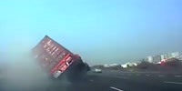 Cargo truck falls on two small cars