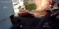 Runaway Tow truck pushes a gas tank against the building causing explosion