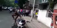 Drugged naked African makes show on the streets of India