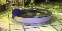The careless man falls into the fountain distracted by the cell phone
