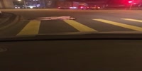 Naked man on drugs rolls in the middle of the road