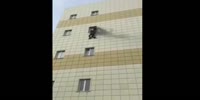 People jump out of the windows of the burning mall