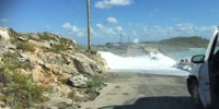 Man swept off bridge by giant waves.