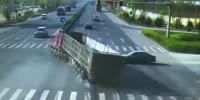 Rider gets knocked by overturning truck survives