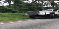 Truck towing bulldozer