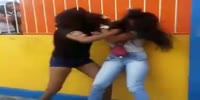 Two girls fight in front of crowd