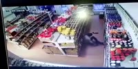 Thug knocks both store owners with bottle of Vodka and takes the cash