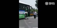 Woman gets knocked by a bus and gets stuck under the wheels