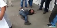 Thug suffers after landing on pavement beaten by mob