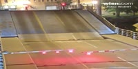 Cyclist falls into draw bridge