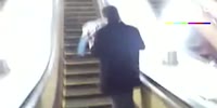 Drunk man falls off an escalator
